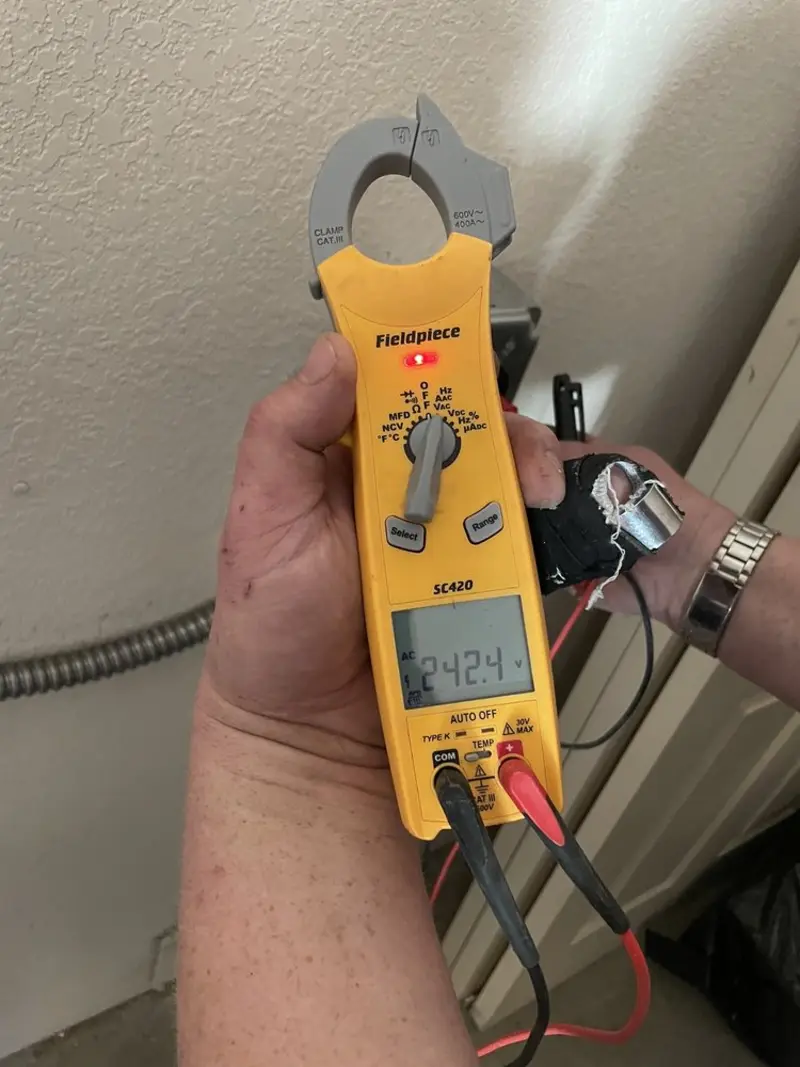 Voltage testing with clamp meter during Recessed Lighting Installation in Atlanta